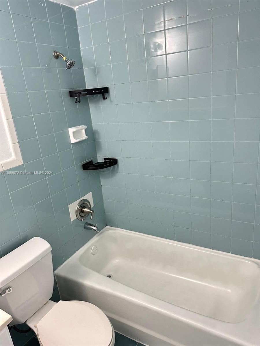 265 East 7th Street Hialeah, FL 33010 - Photo 25 of 28 a bathroom with a toilet and a bathtub