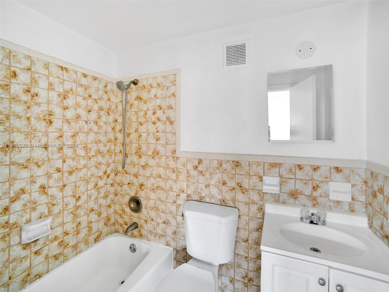 265 East 7th Street Hialeah, FL 33010 - Photo 3 of 28 a bathroom with a sink toilet and shower