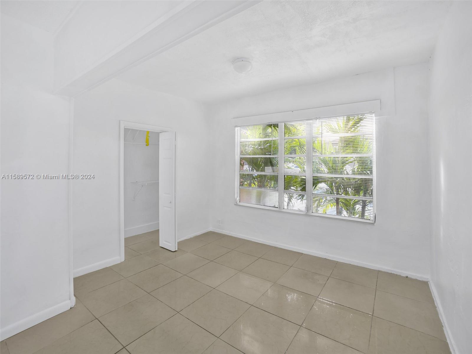 265 East 7th Street Hialeah, FL 33010 - Photo 4 of 28 an empty room with windows