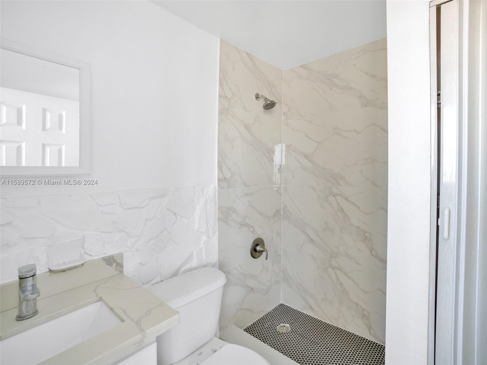 265 East 7th Street Hialeah, FL 33010 - Photo 8 of 28 a bathroom with a sink a toilet and shower