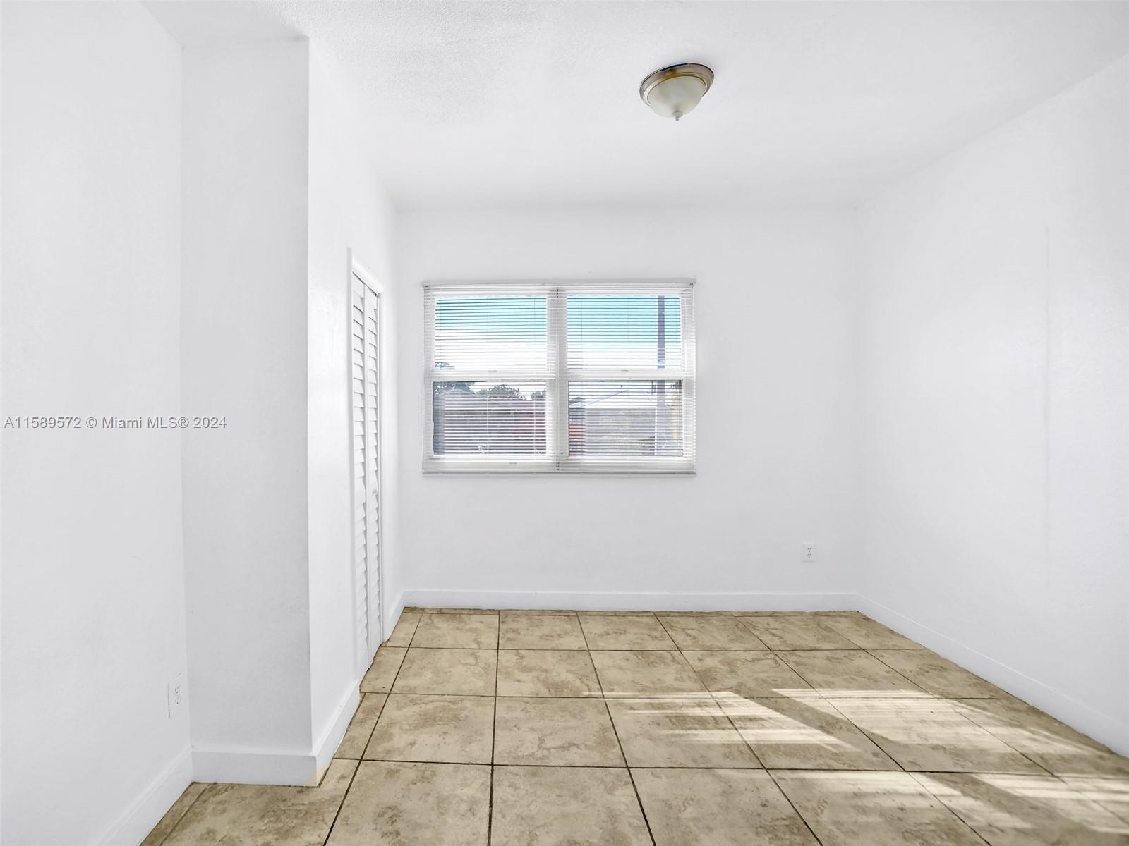 265 East 7th Street Hialeah, FL 33010 - Photo 9 of 28 a view of an empty room and window