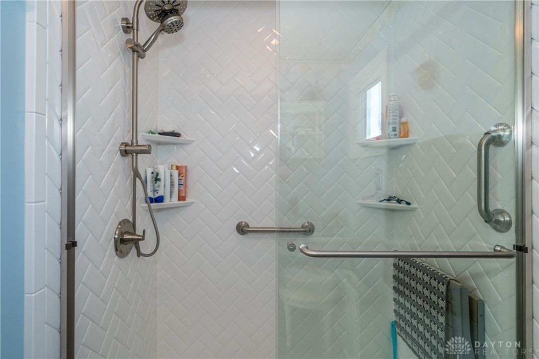 1599 Garringer Road Jamestown, OH 45335 - Photo 18 of 73 This sleek shower features modern tile work and convenient accessibility features.