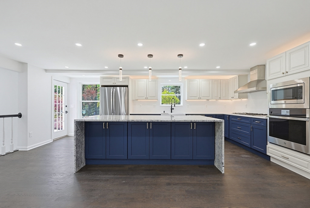 175 Pleasant Street Upton, MA 01568 - Photo 11 of 39 a kitchen with wooden cabinets and center island