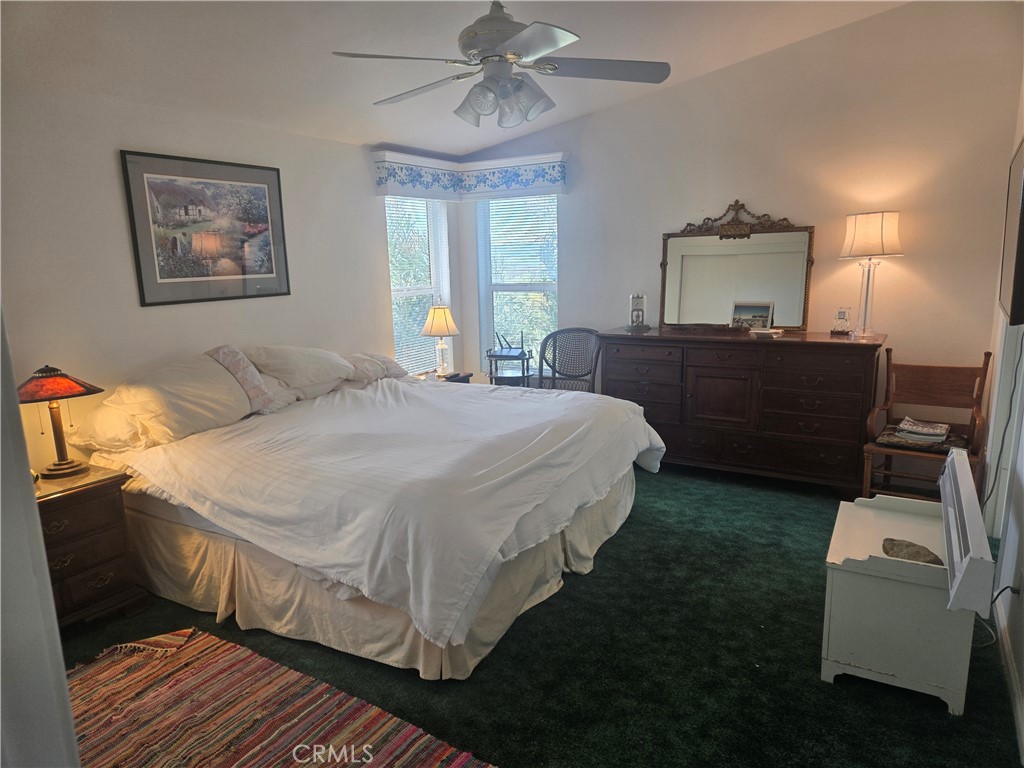 9308 Chimney Rock Road Paso Robles, CA 93446 - Photo 7 of 8 a bedroom with a bed and a chandelier