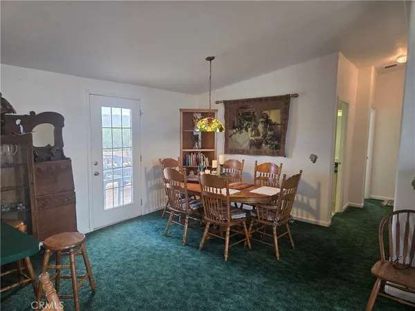 a view of a dining room with furniture and window