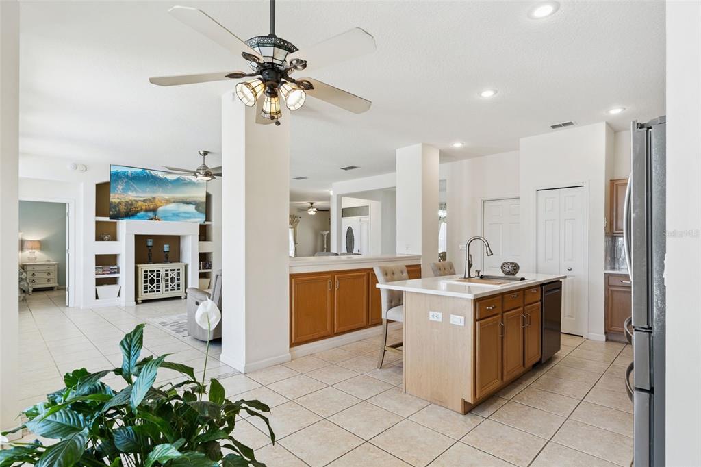 13319 Via Roma Circle Clermont, FL 34711 - Photo 12 of 43 a kitchen with stainless steel appliances granite countertop a stove oven and a refrigerator