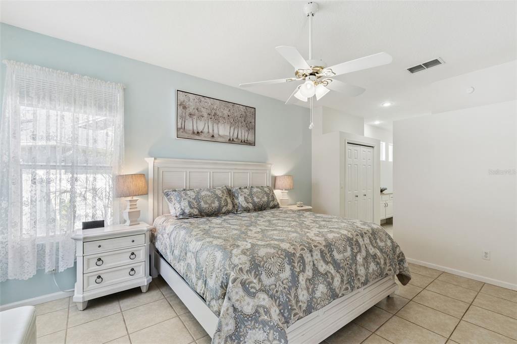 13319 Via Roma Circle Clermont, FL 34711 - Photo 16 of 43 a bedroom with a large bed and a window