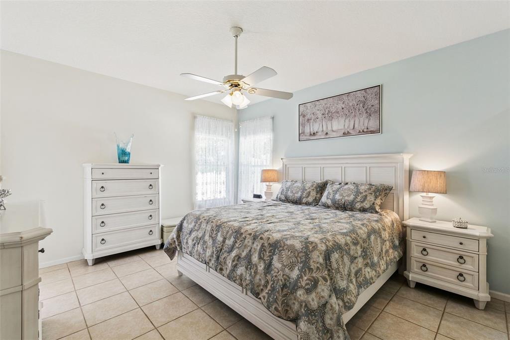 13319 Via Roma Circle Clermont, FL 34711 - Photo 17 of 43 a bedroom with a bed and a dresser