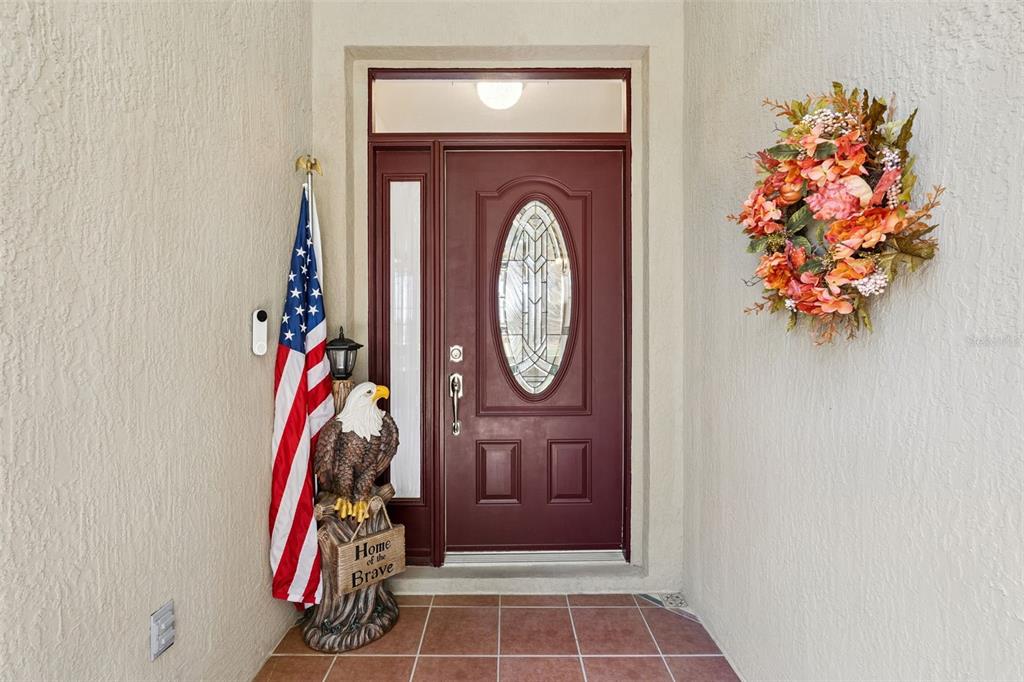 13319 Via Roma Circle Clermont, FL 34711 - Photo 2 of 43 a view of a entryway with a flower pot and a wooden floor