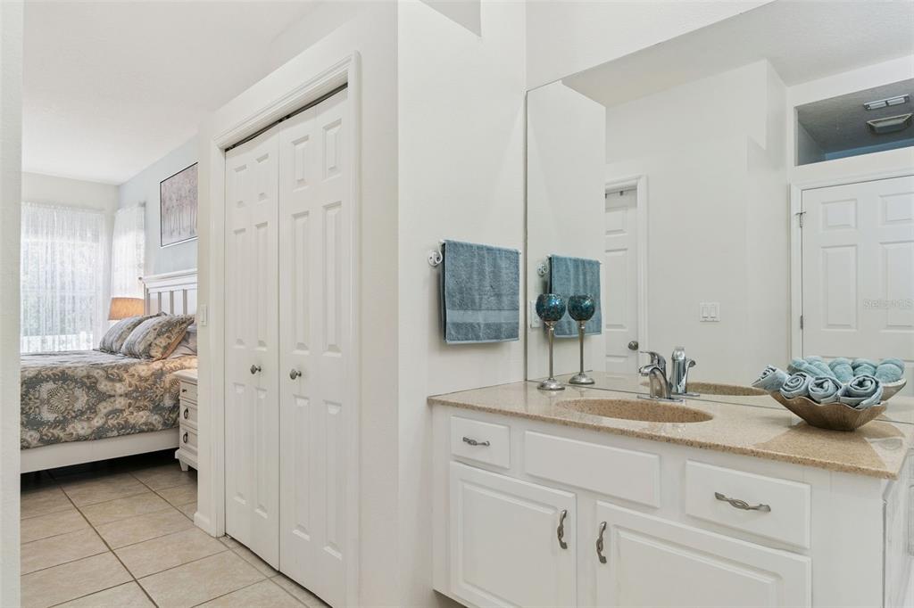 13319 Via Roma Circle Clermont, FL 34711 - Photo 21 of 43 a en suite bathroom with a granite countertop sink and a mirror