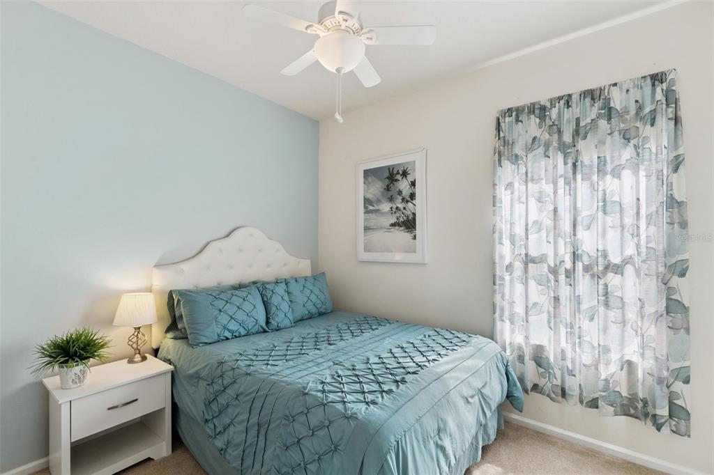 13319 Via Roma Circle Clermont, FL 34711 - Photo 24 of 43 a bedroom with a bed and a window