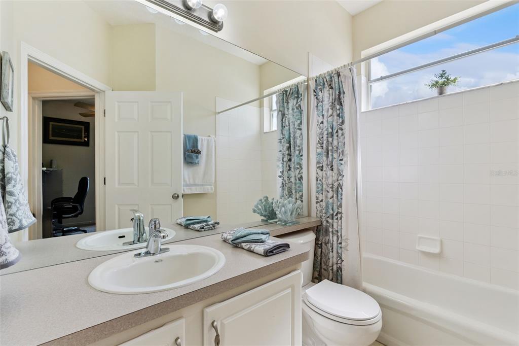 13319 Via Roma Circle Clermont, FL 34711 - Photo 25 of 43 a bathroom with a sink a toilet and shower