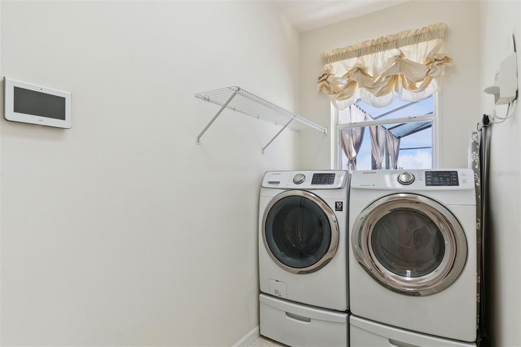 13319 Via Roma Circle Clermont, FL 34711 - Photo 28 of 43 a utility room with dryer and washer