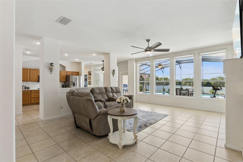 13319 Via Roma Circle Clermont, FL 34711 - Photo 3 of 43 a living room with furniture and large windows