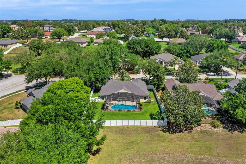 13319 Via Roma Circle Clermont, FL 34711 - Photo 39 of 43 an aerial view of a house with a yard and lake view