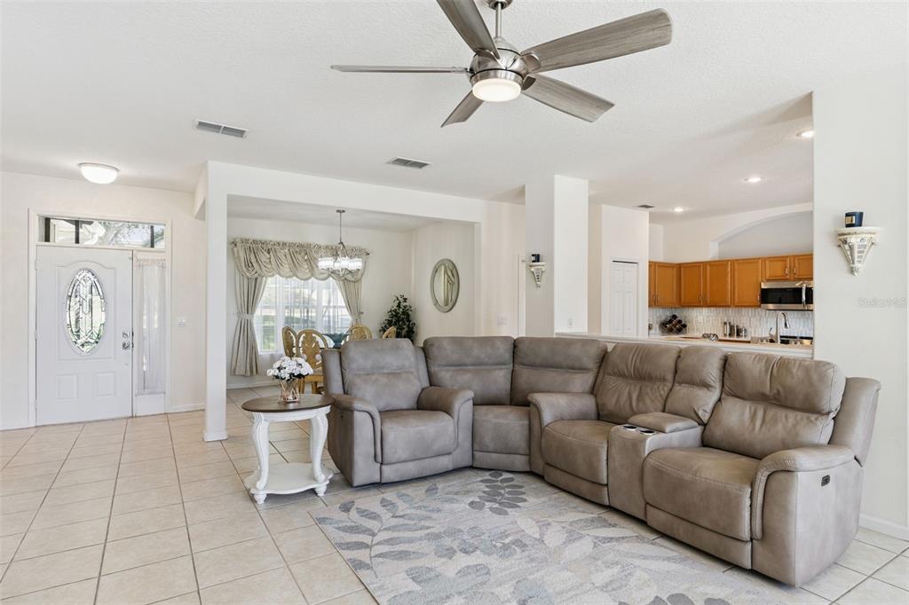 13319 Via Roma Circle Clermont, FL 34711 - Photo 5 of 43 a living room with furniture and a chandelier