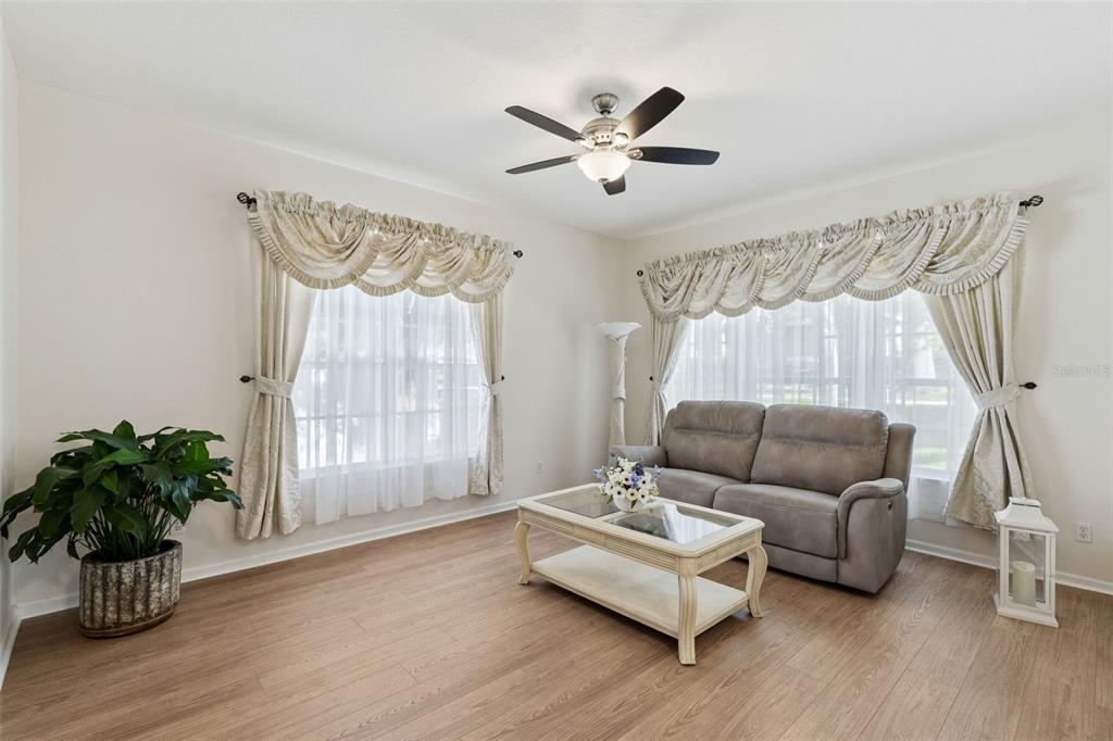 13319 Via Roma Circle Clermont, FL 34711 - Photo 6 of 43 a living room with furniture and a potted plant