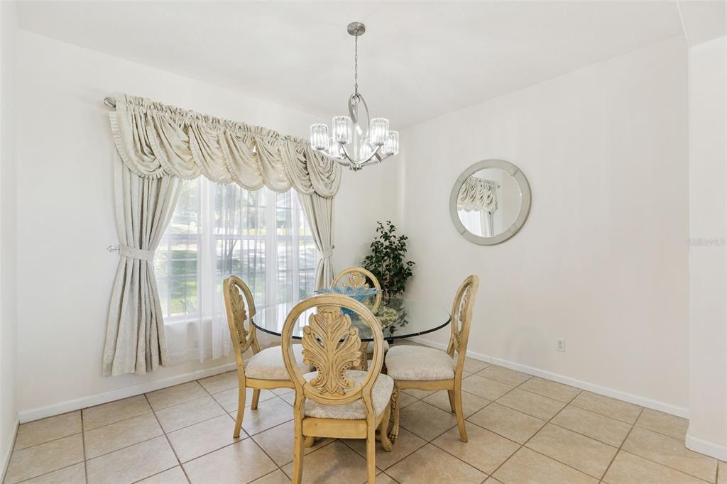 13319 Via Roma Circle Clermont, FL 34711 - Photo 7 of 43 a view of a dining room with furniture and chandelier