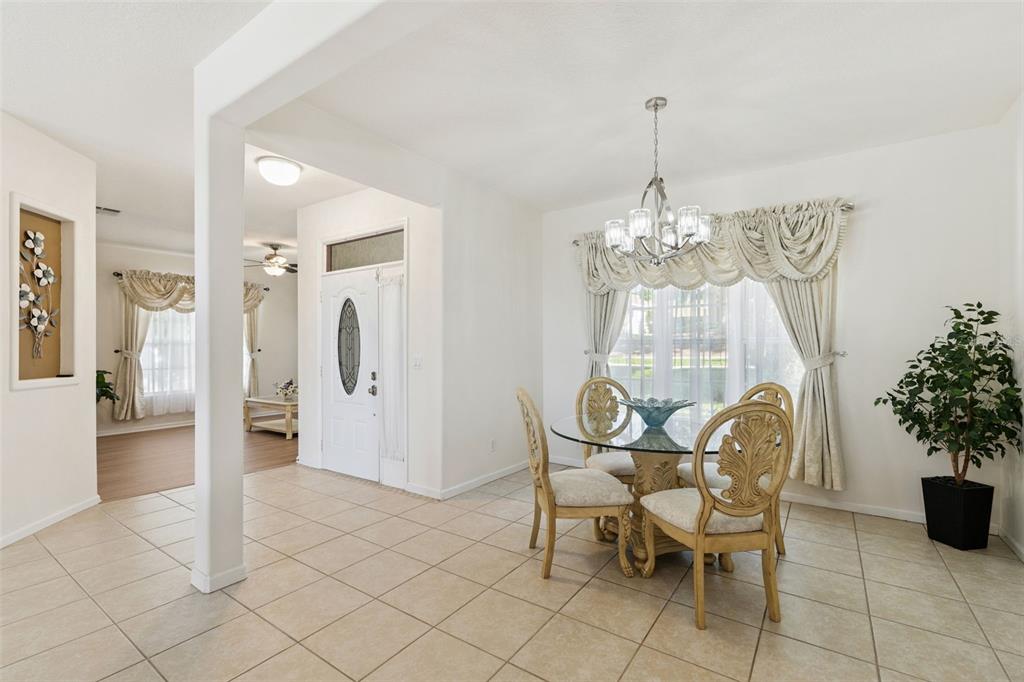 13319 Via Roma Circle Clermont, FL 34711 - Photo 8 of 43 a view of a dining room with furniture and chandelier