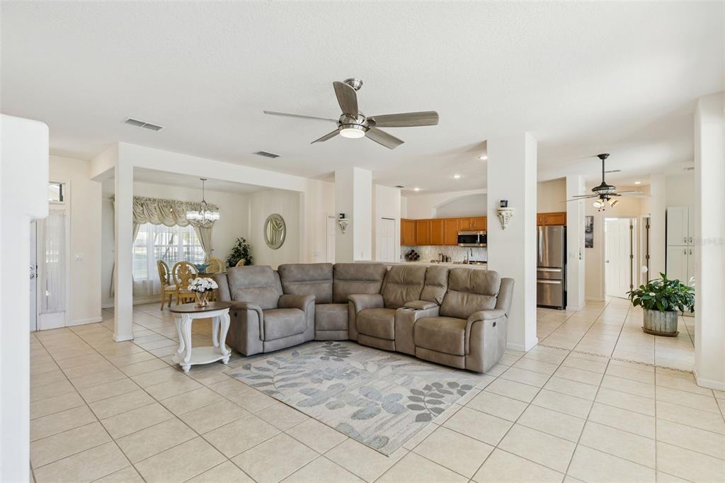 13319 Via Roma Circle Clermont, FL 34711 - Photo 9 of 43 a living room with furniture and a chandelier