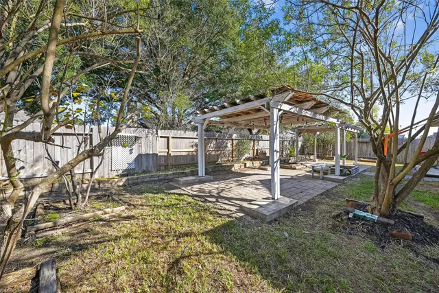 a view of a patio with a table and chairs under an umbrella
