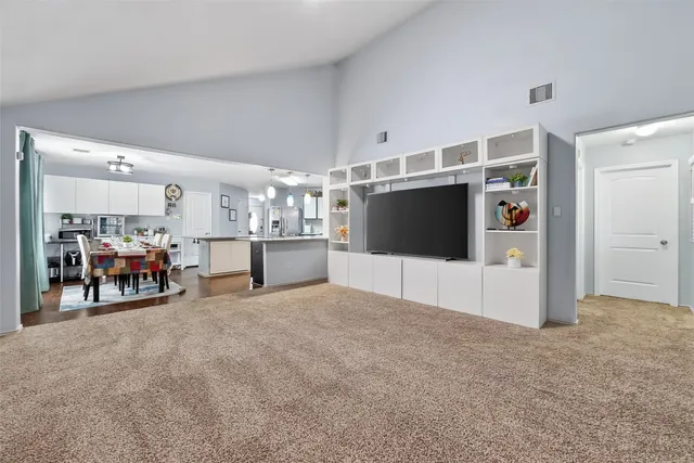 a view of a room with furniture and refrigerator