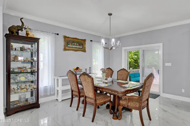 a living room with stainless steel appliances furniture and a kitchen view