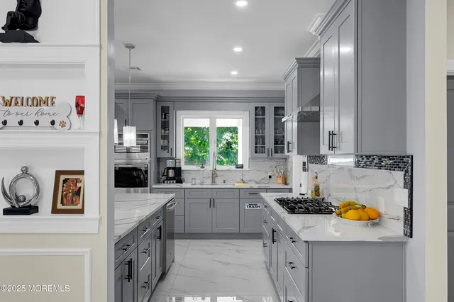 a kitchen with stainless steel appliances granite countertop a stove and a cabinets