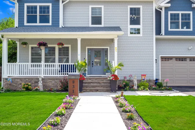 a front view of a house with a garden and yard