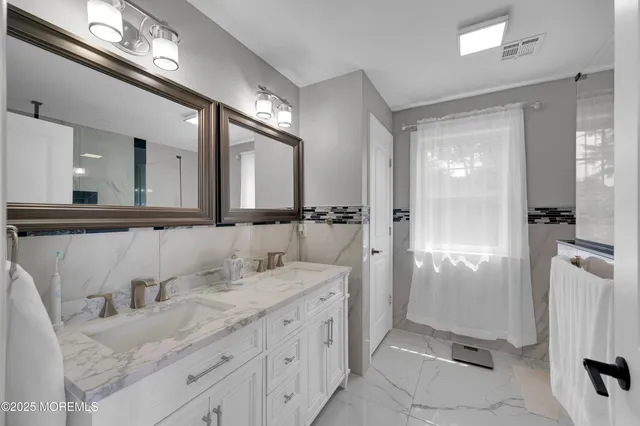 a bedroom with bed and a view of living room