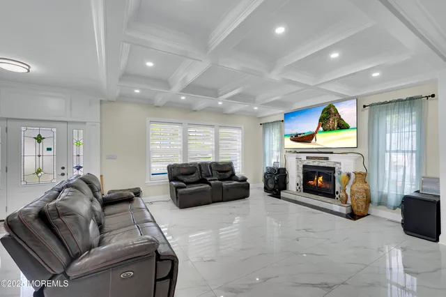 a living room with furniture a fireplace and a flat screen tv