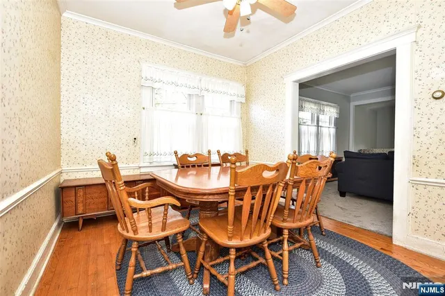 a dining room with furniture and wooden floor