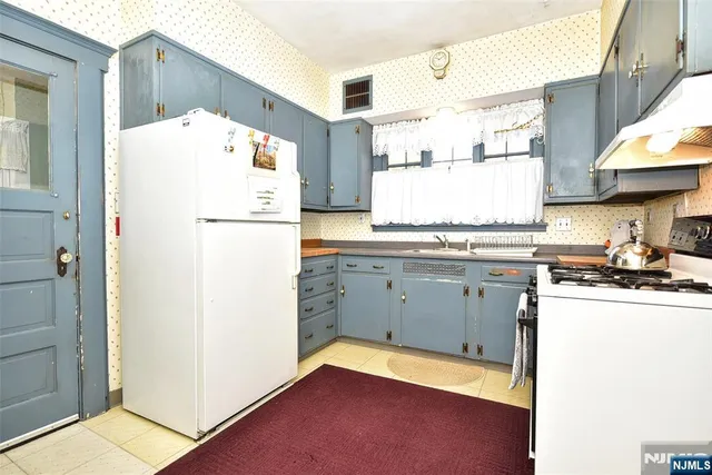 a kitchen with a refrigerator a stove a sink and a microwave