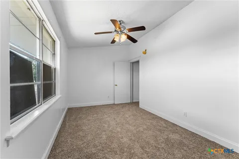 a bathroom with a bathtub and next to a window