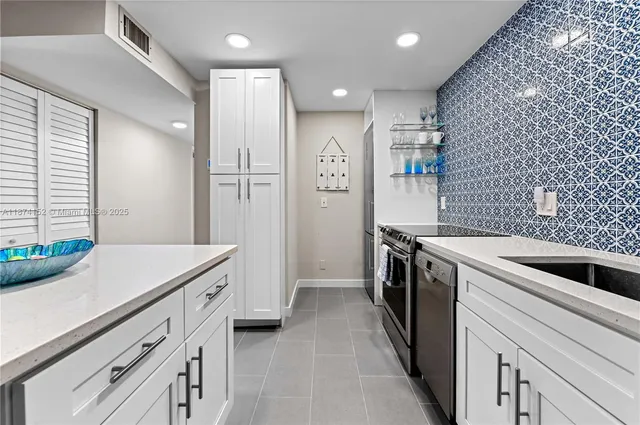 a kitchen with a sink and stainless steel appliances