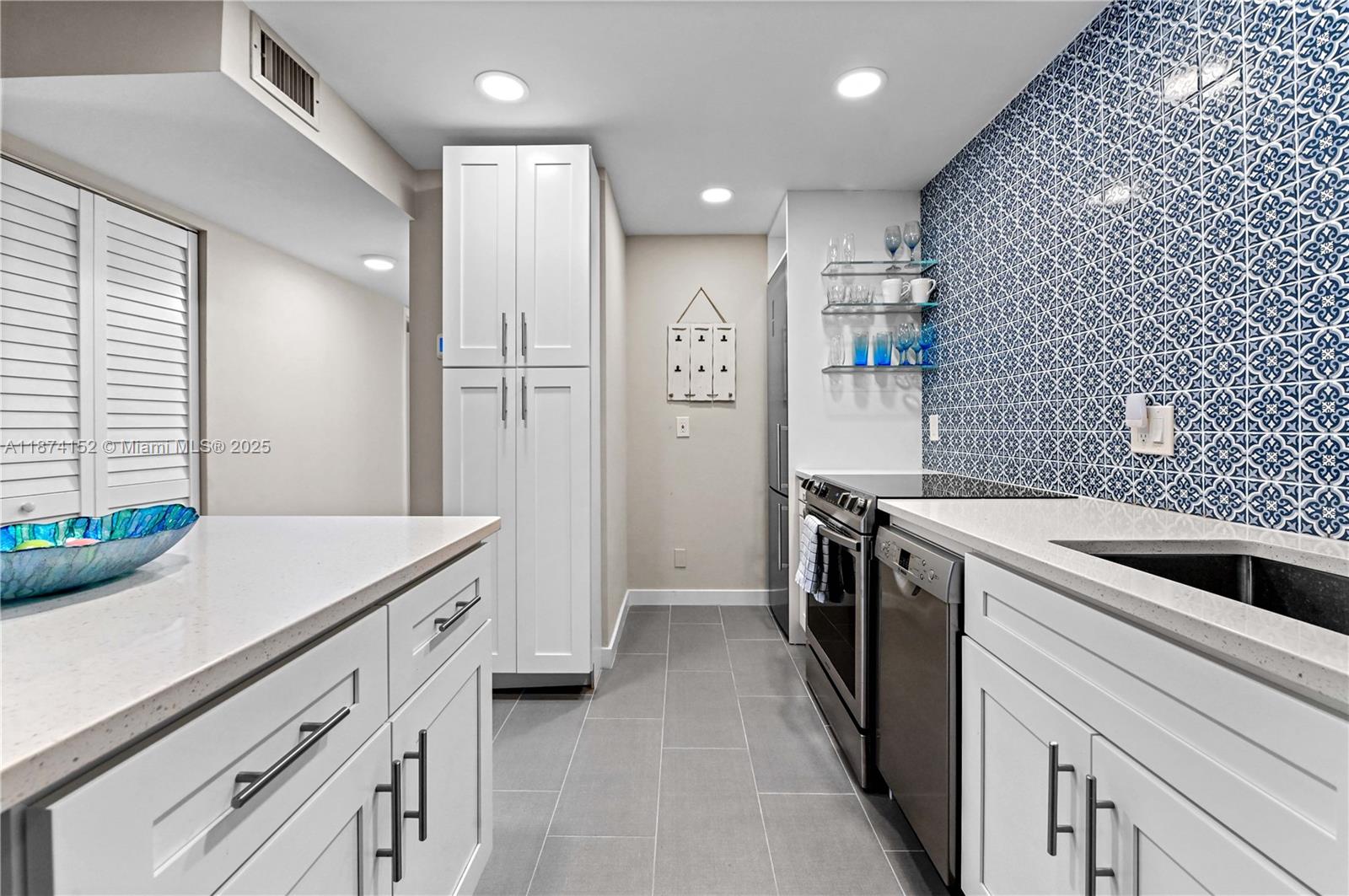 812 Sky Pine Way, Unit C2 Greenacres, FL 33415 - Photo 11 of 25 a kitchen with a sink and stainless steel appliances