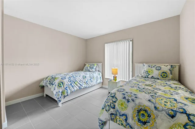 a bedroom with a bed and a lamp