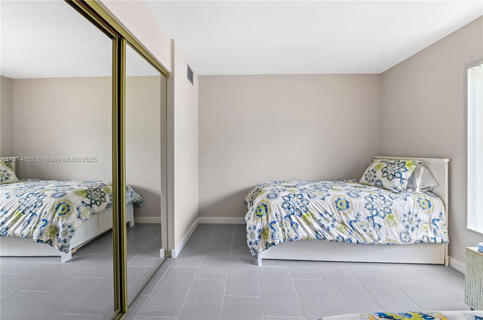 812 Sky Pine Way, Unit C2 Greenacres, FL 33415 - Photo 17 of 25 a bedroom with a bed and a painting on the wall