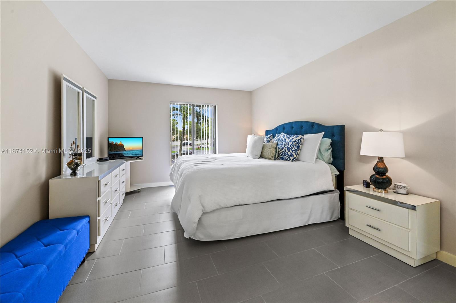 812 Sky Pine Way, Unit C2 Greenacres, FL 33415 - Photo 19 of 25 a bedroom with a large bed and a couch