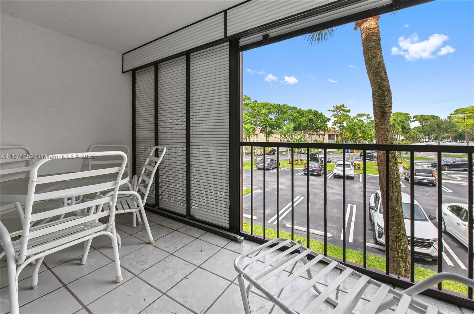 812 Sky Pine Way, Unit C2 Greenacres, FL 33415 - Photo 23 of 25 a balcony with table and chairs
