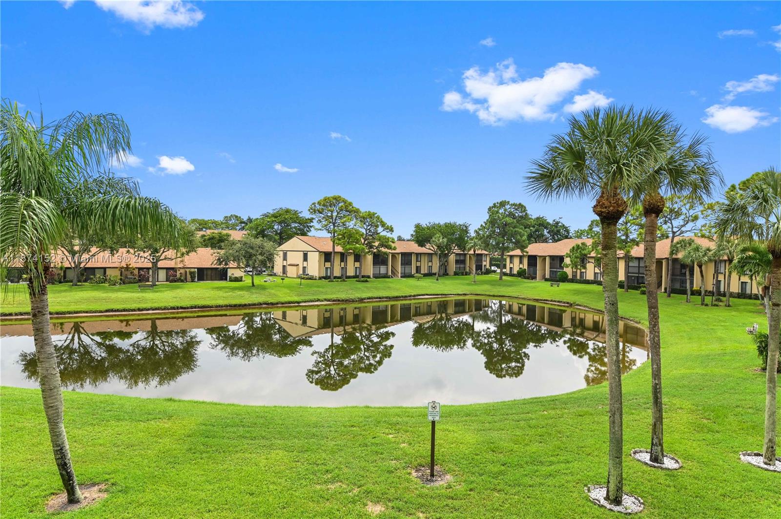 812 Sky Pine Way, Unit C2 Greenacres, FL 33415 - Photo 25 of 25 a view of a golf course with a lake