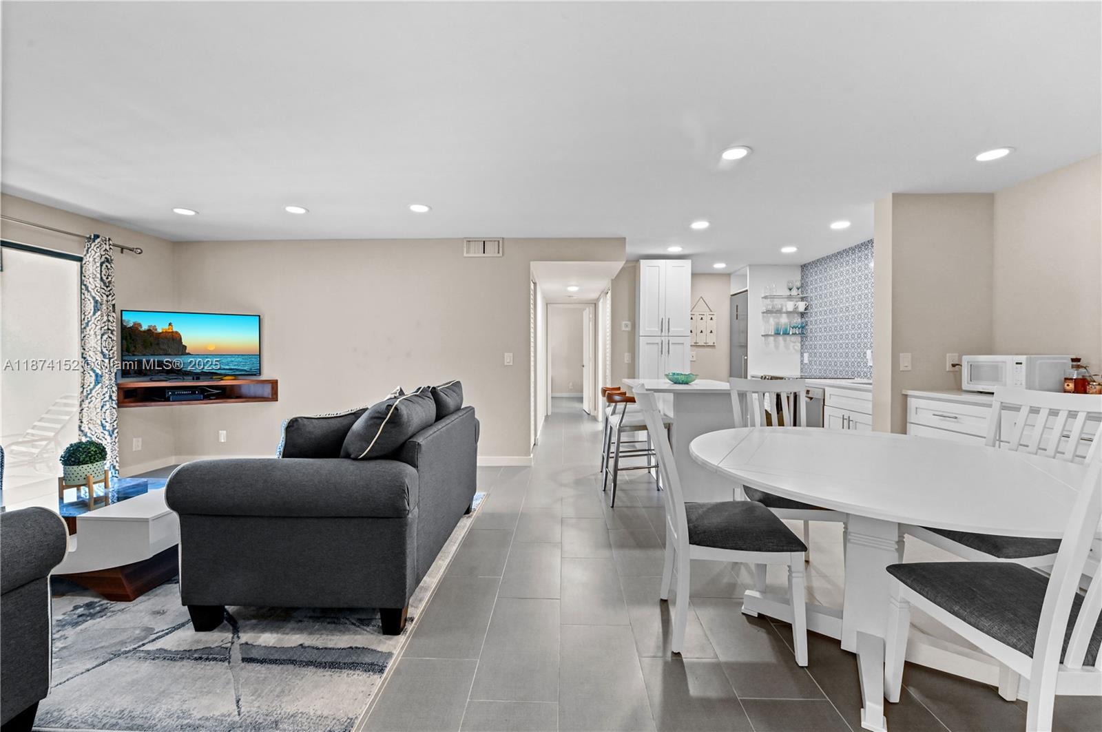 812 Sky Pine Way, Unit C2 Greenacres, FL 33415 - Photo 3 of 25 a living room with furniture and a flat screen tv