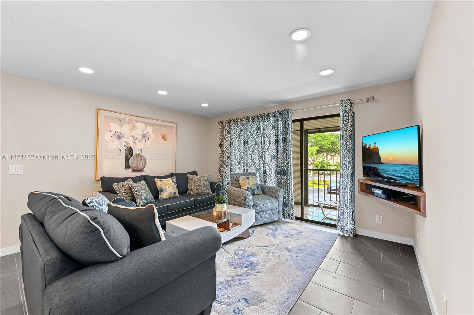 812 Sky Pine Way, Unit C2 Greenacres, FL 33415 - Photo 5 of 25 a living room with furniture and a flat screen tv