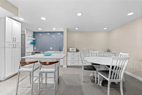a dining room with a table and chairs