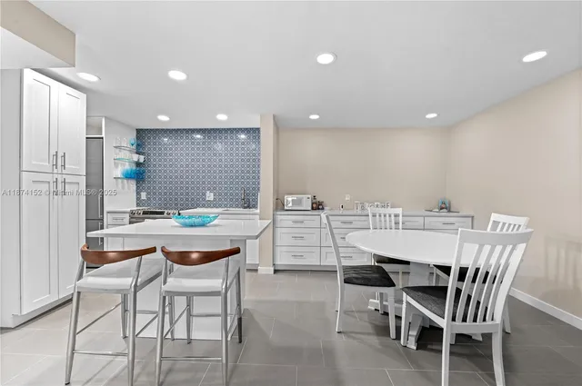 a dining room with a table and chairs