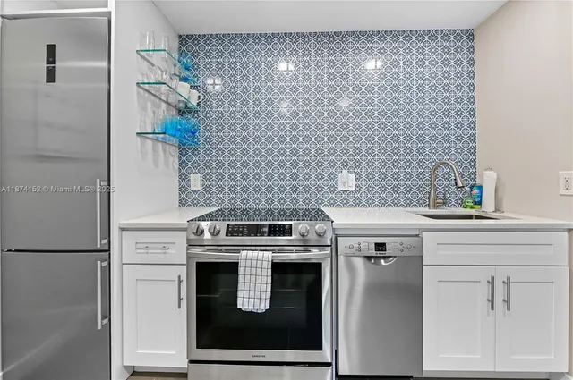 a close view of a stove and a utility room with washer and dryer