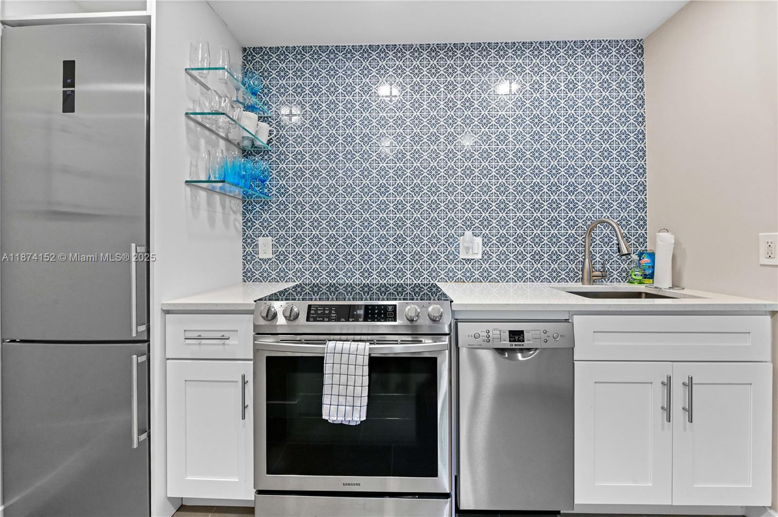 812 Sky Pine Way, Unit C2 Greenacres, FL 33415 - Photo 10 of 25 a close view of a stove and a utility room with washer and dryer