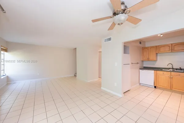 a view of a kitchen with a sink and cabinets