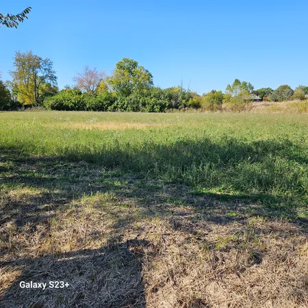 a view of a lake with a yard