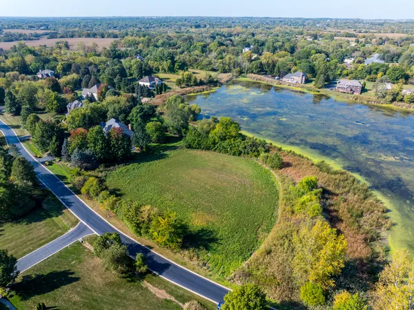 an aerial view of a residential houses with outdoor space